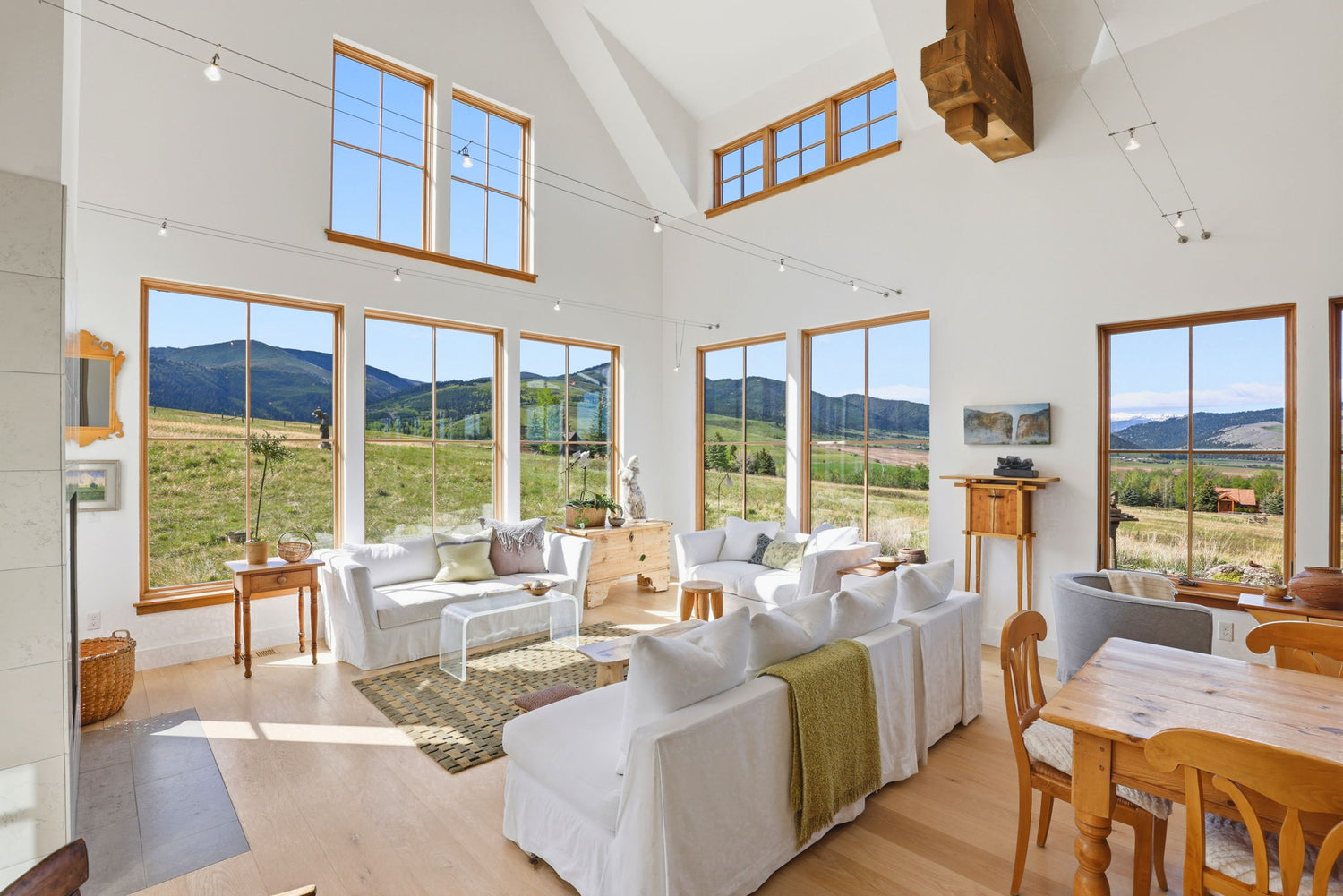 Light and bright furnished living room with large windows and Gallatin mountain views
