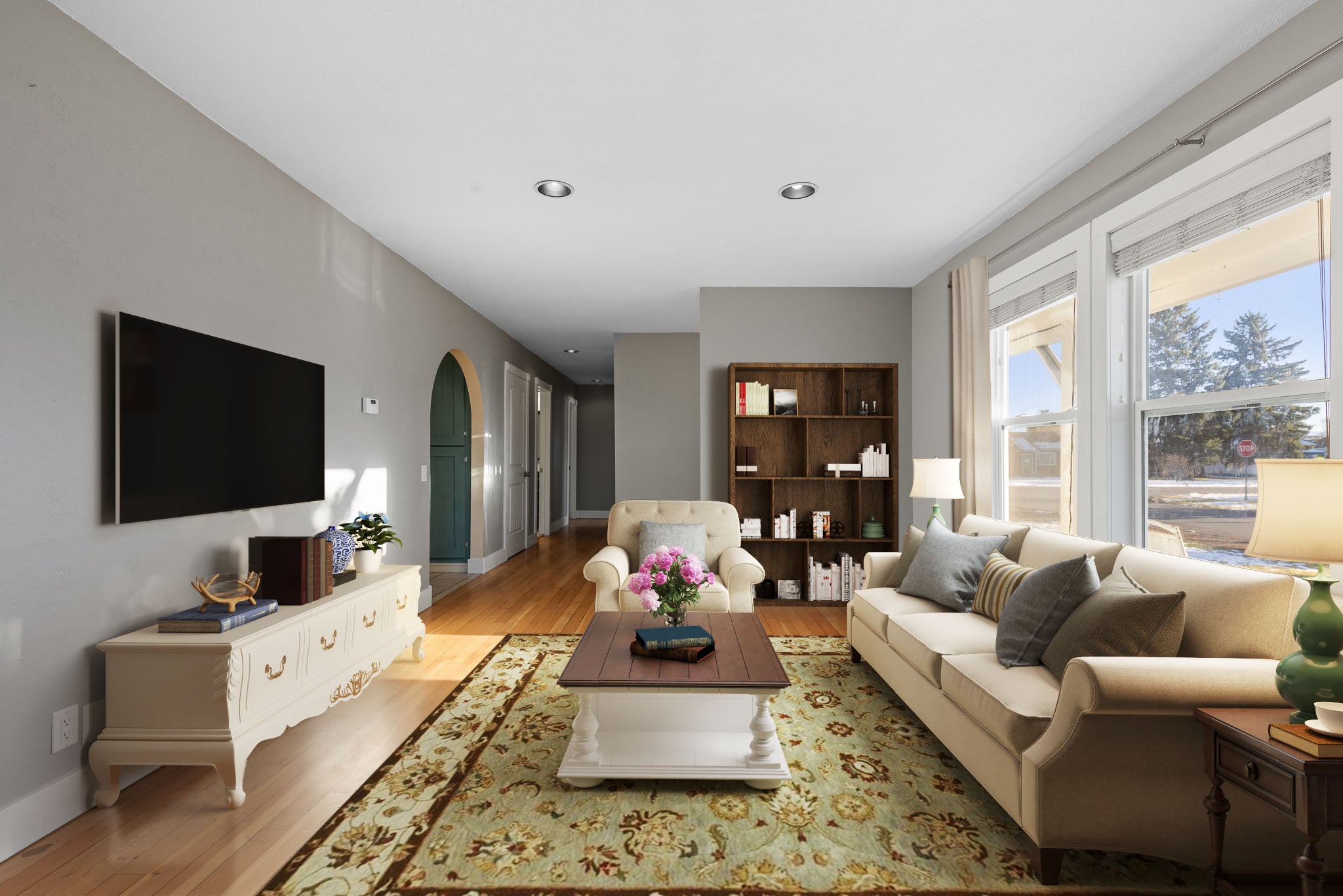 Virtual staging of living room furniture in a mid-century living room with grey walls and oak flooring in Bozeman, Montana
