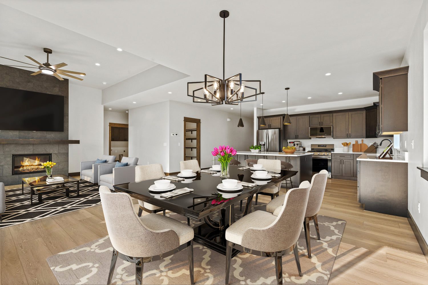 Modern virtually-staged living area with dining table and kitchen in a well-lit Bozeman home